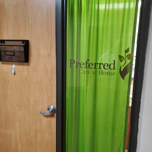 Entrance to a business office with a green curtain and signage.