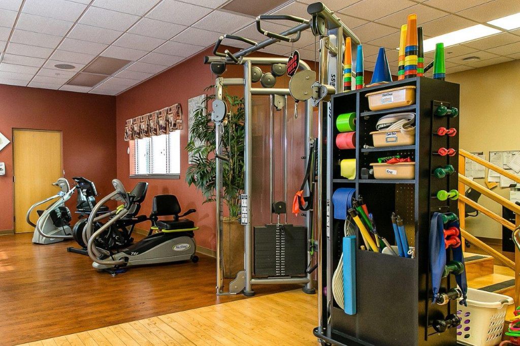 A well-equipped gym with exercise machines and training tools.