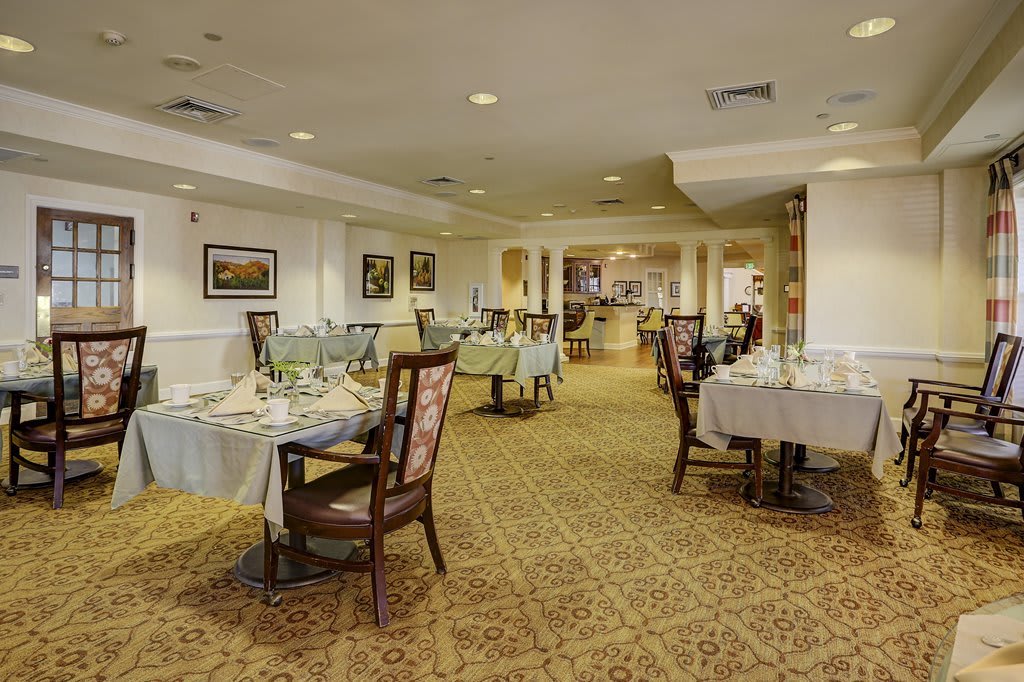 An elegant dining room with neatly arranged tables and chairs.