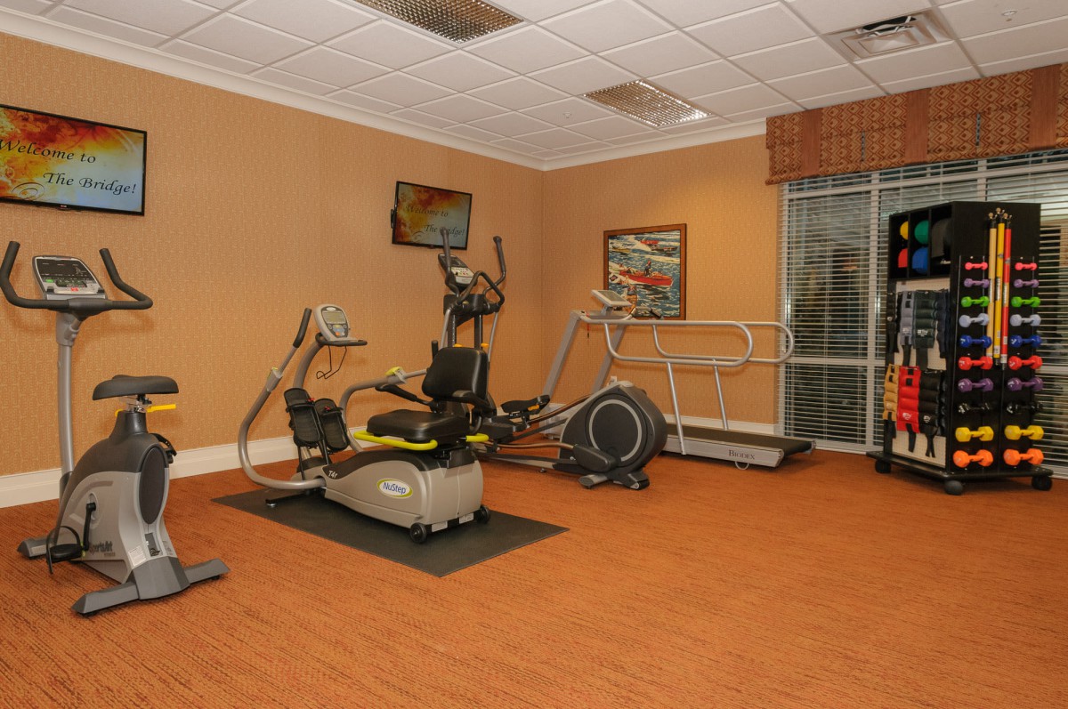 A well-equipped gym with various exercise machines.
