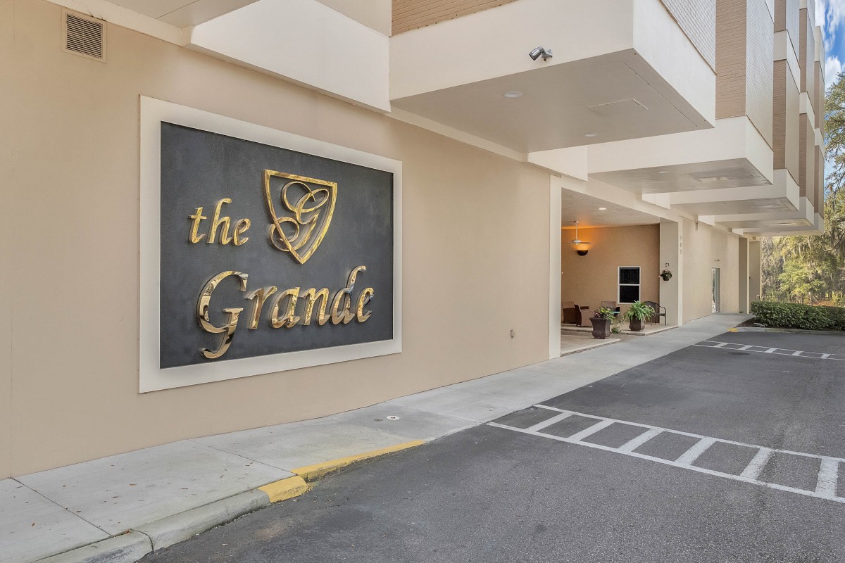 Entrance of a building with 'The Grande' sign.