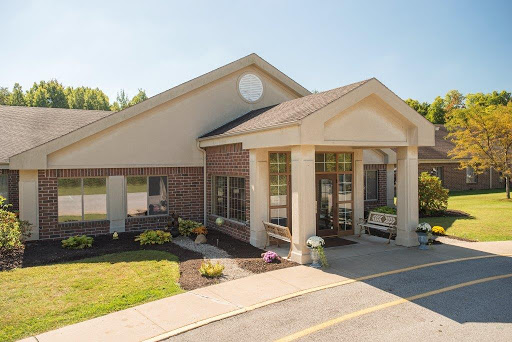 A welcoming entrance to a well-maintained commercial building on a sunny day.