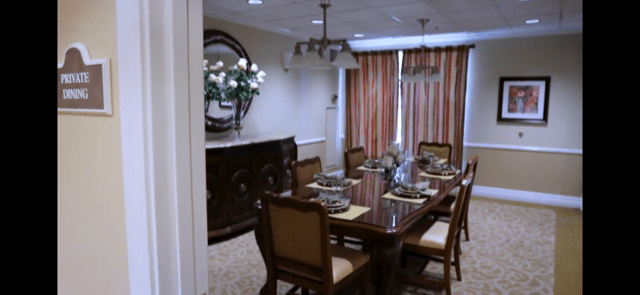 A neatly arranged dining room with an elegant table setting and stylish decor.
