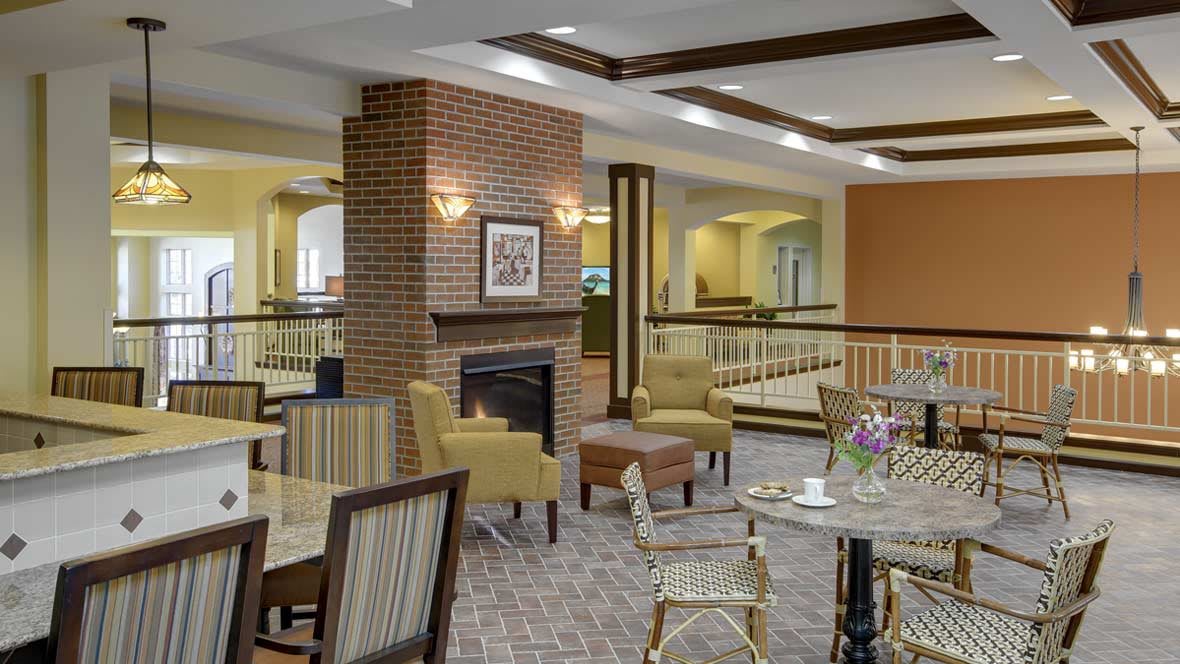 A cozy lobby seating area featuring a fireplace and comfortable armchairs.
