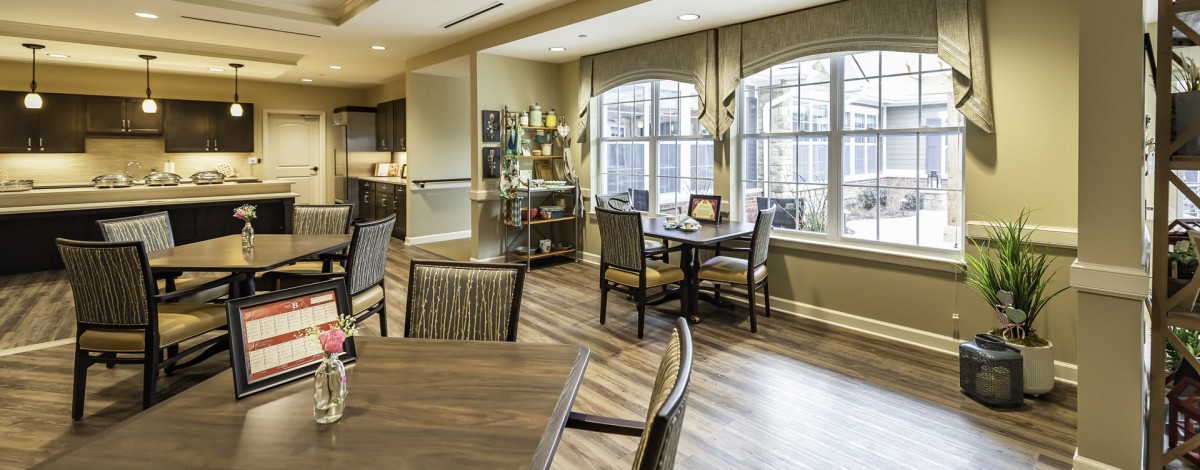 A well-lit dining area with wooden floors and tasteful decor.