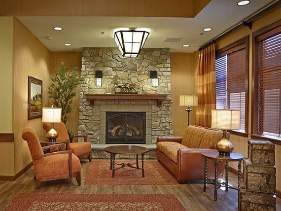 Cozy living room with a fireplace, comfortable seating, and warm lighting.