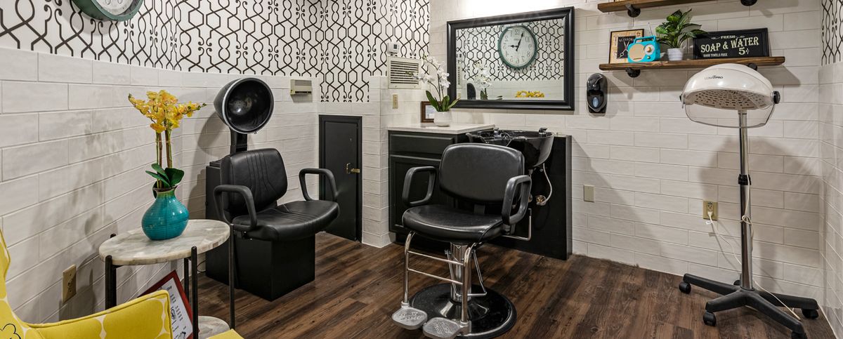 Modern barbershop interior with stylish decor and equipment.