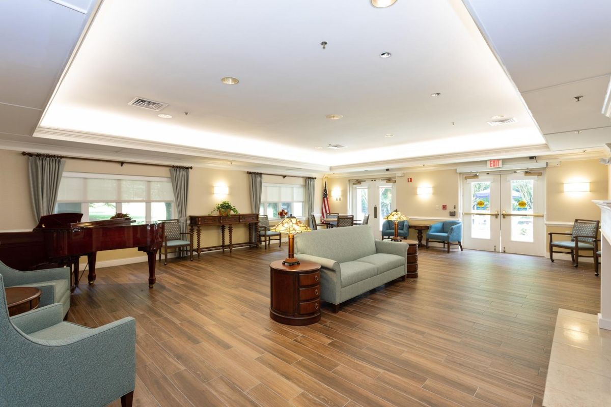 A spacious lobby area featuring comfortable seating and warm lighting.