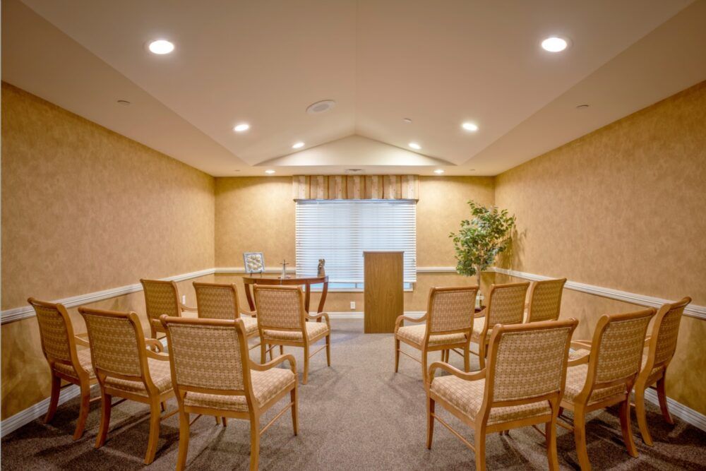 A small conference room with a podium and neatly arranged chairs.