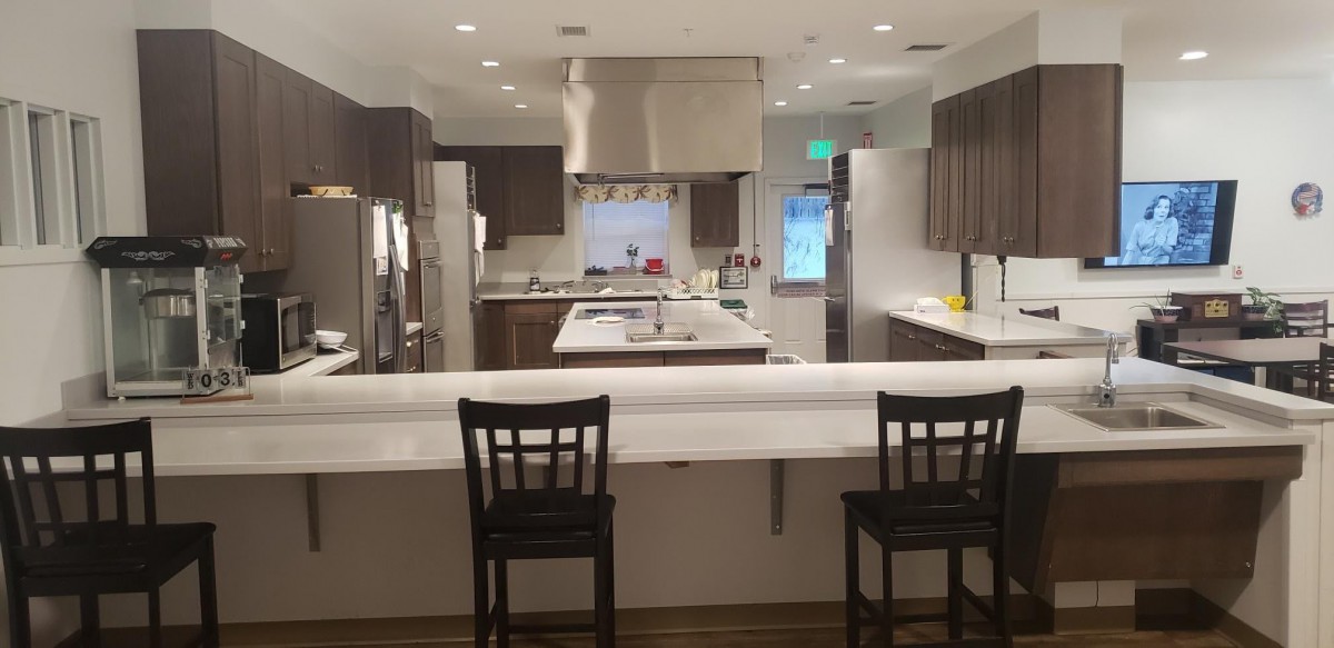 A spacious modern kitchen with a large countertop and stainless steel appliances.
