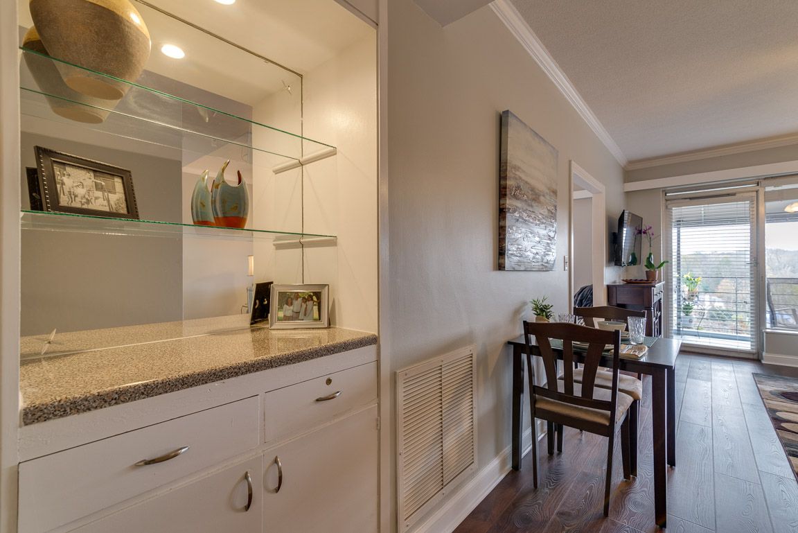 A cozy dining area with decorative shelves and modern furnishings.