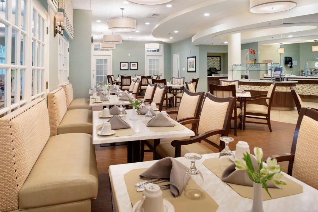 An elegant restaurant dining area with neatly arranged tables and chairs.