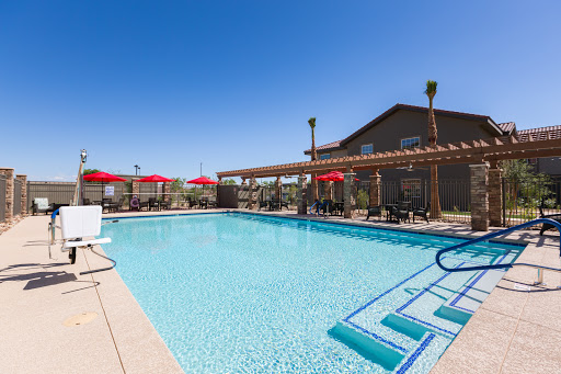 A serene outdoor swimming pool area perfect for relaxation under the sun.