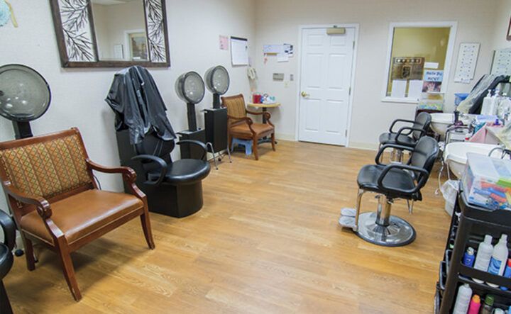 A view inside a hair salon featuring styling chairs, mirrors, and a waiting area.