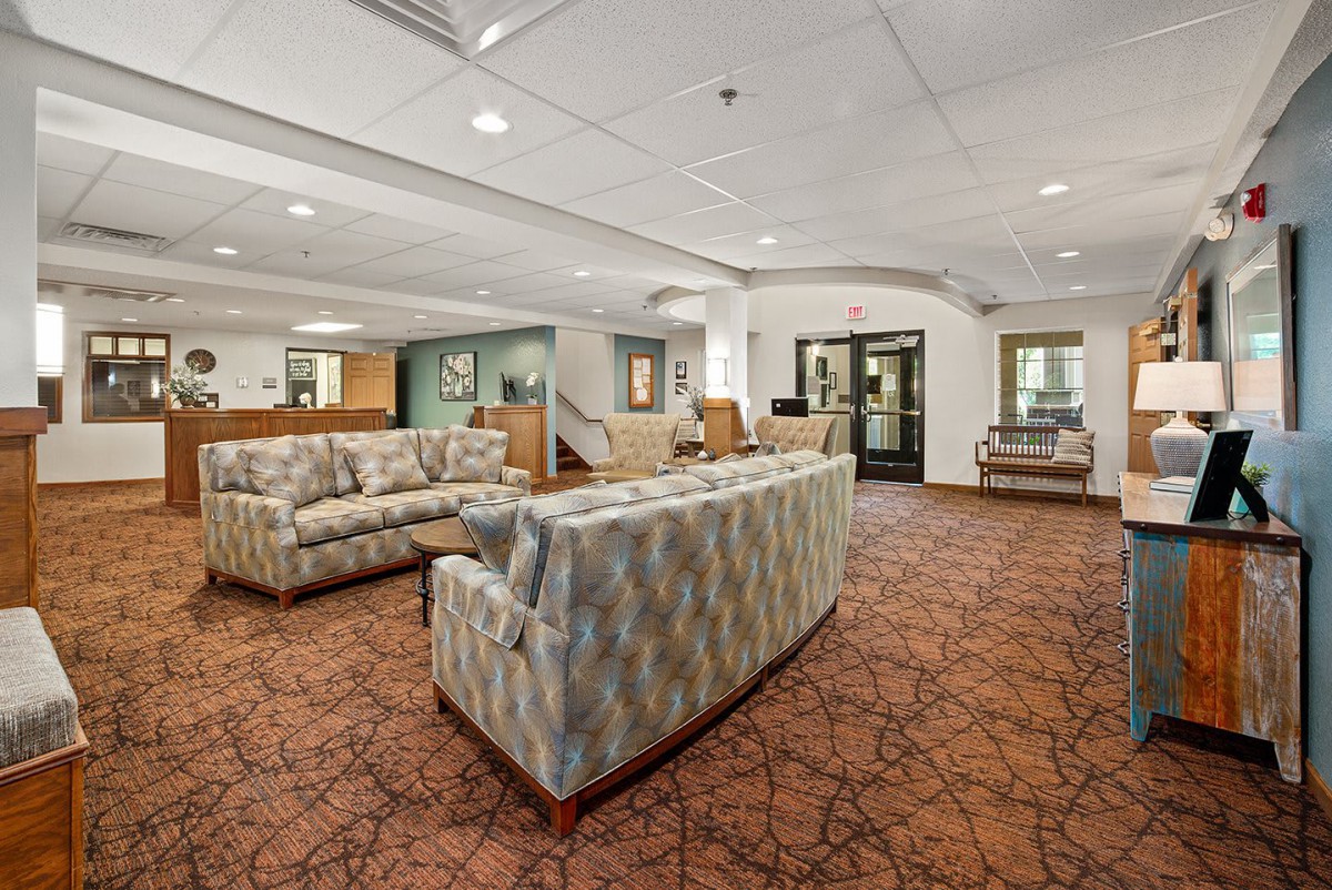 A spacious lobby area with comfortable seating and a warm atmosphere.