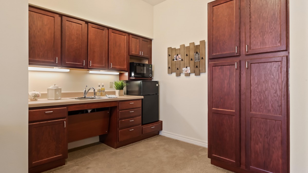 A cozy kitchen with wooden cabinets, a microwave, and a sink.