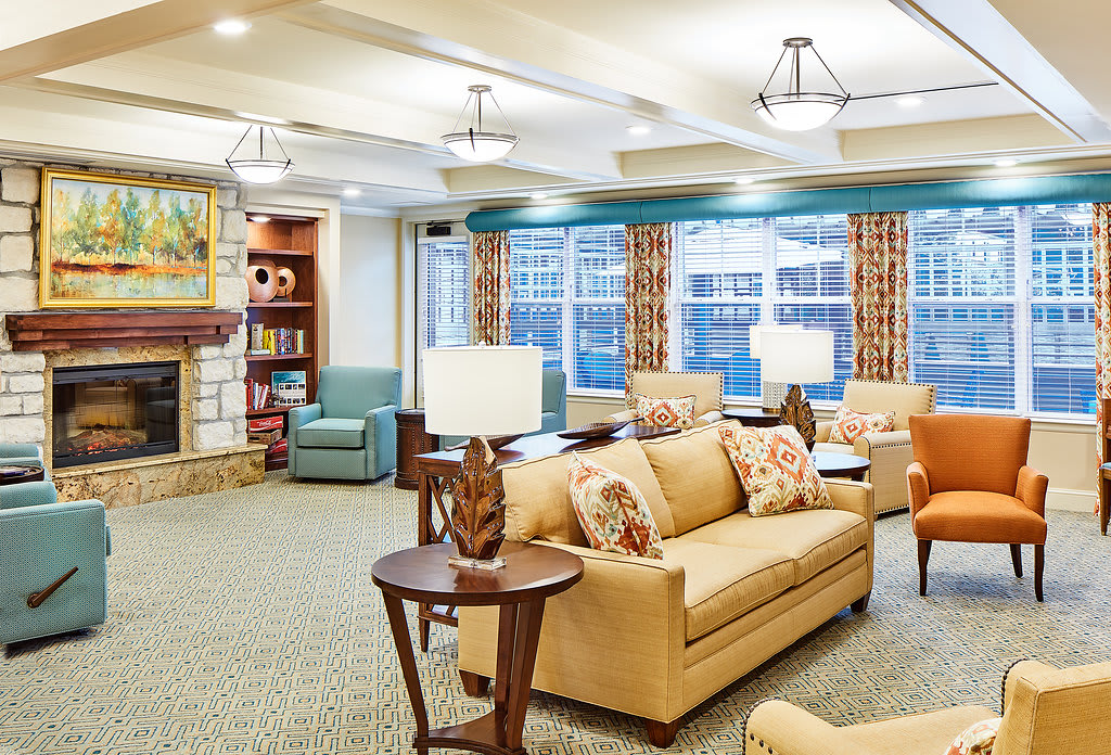 A cozy living room with comfortable sofas, lamps, and a warm atmosphere.