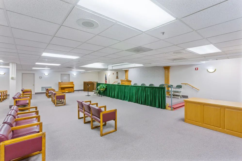 A spacious courtroom with seating arrangements and a judge's podium.
