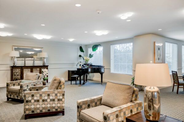 A cozy living room with a grand piano and comfortable seating.