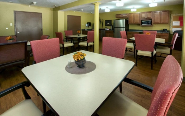 A modern kitchen and dining area with tables and chairs.