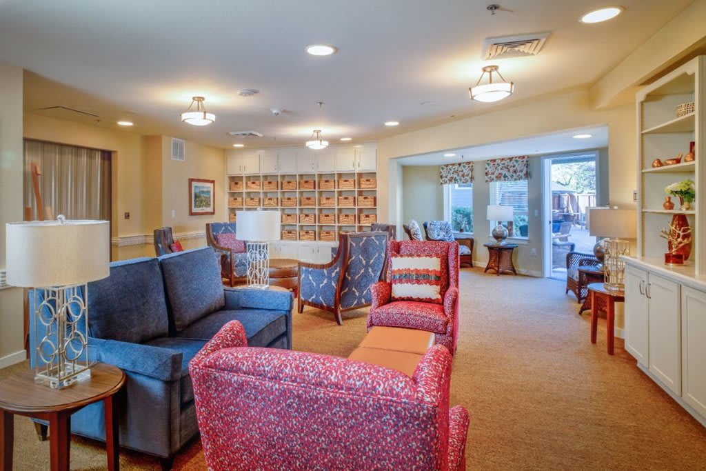 A bright and cozy lounge area with various chairs and sofas.
