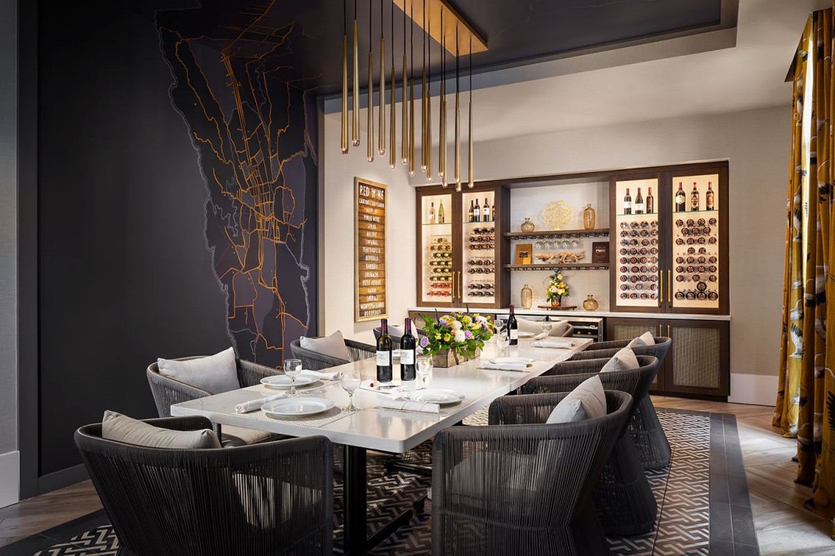 A luxurious dining room with elegant decor and a wine display.