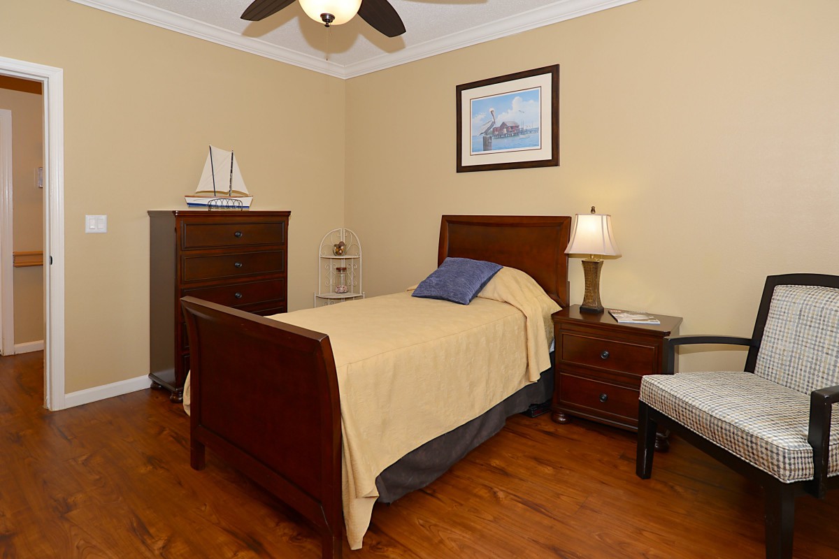 A cozy bedroom with a single bed, nightstand, and tasteful decor.