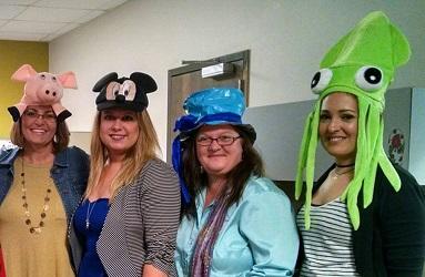 A group of friends showing off their playful hats at a fun event.