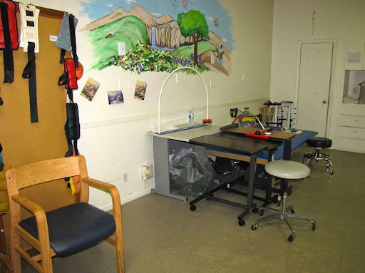 A creative workspace featuring a mural and various furniture.
