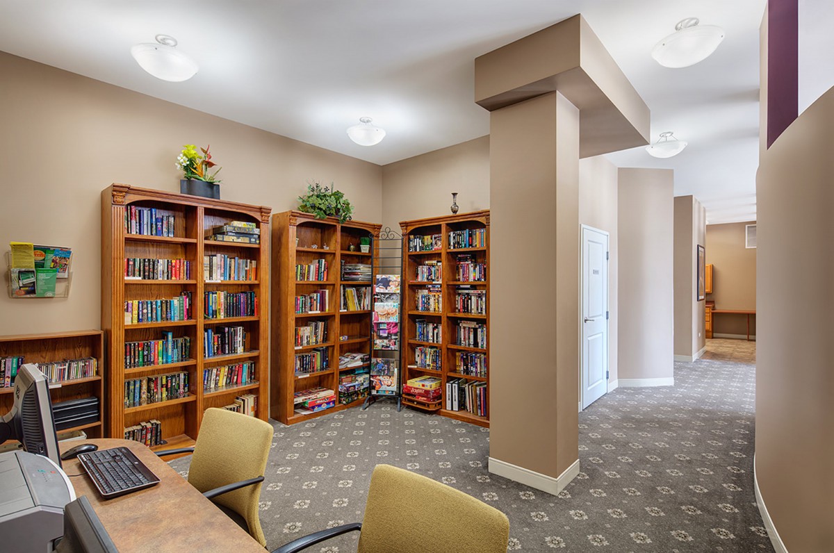 A cozy library corner with bookshelves filled with various books.