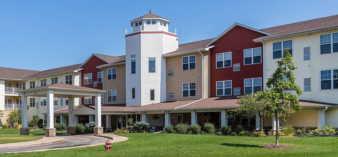 A well-maintained residential building with a tower, likely serving as a senior living or retirement home.