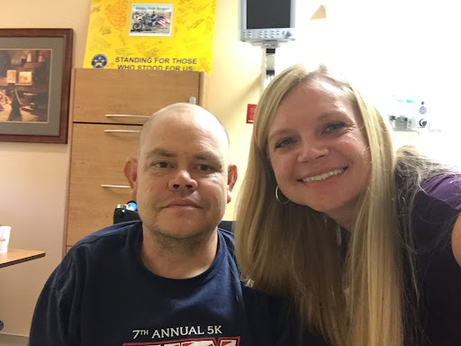 A joyful moment shared between two friends in a hospital setting.