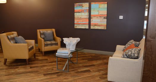 A modern living room with stylish furniture and abstract artwork.