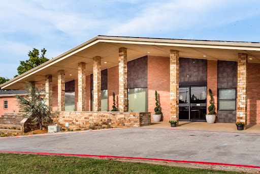 A modern building featuring brick architecture with distinct columns and a welcoming entrance.
