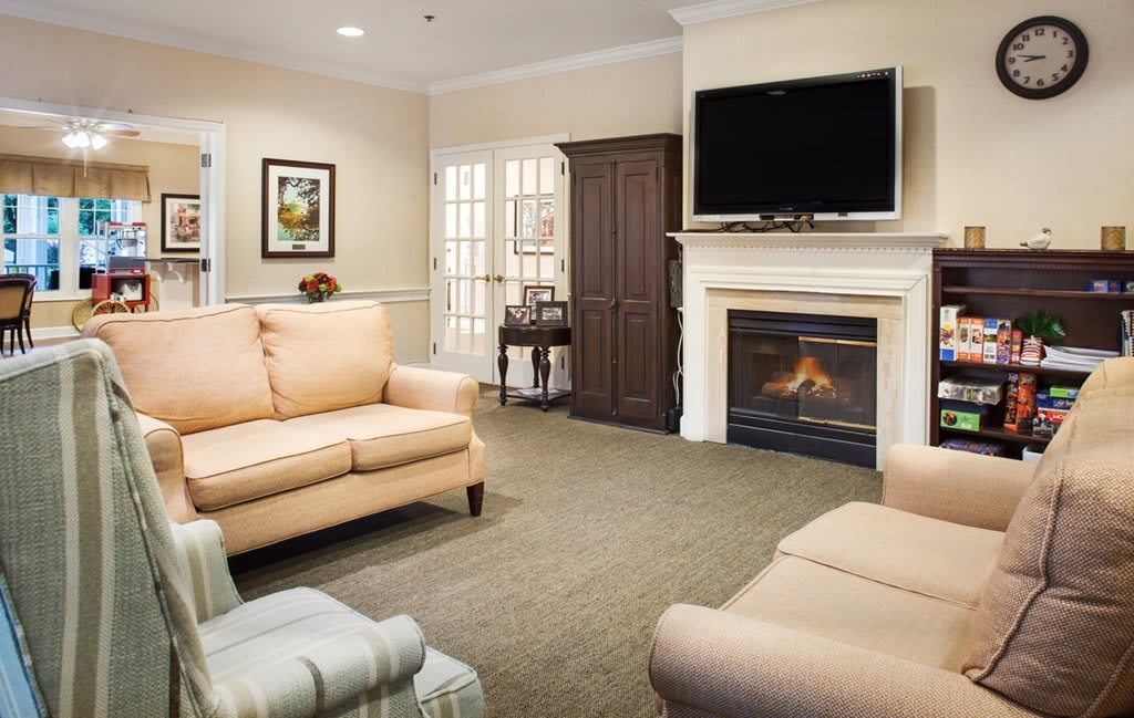 A cozy living room featuring a fireplace and comfortable seating.