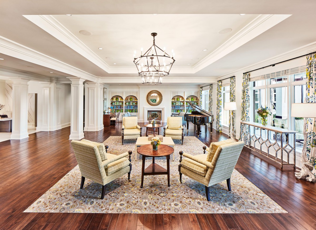 Elegant living room with hardwood floors and cozy seating around a central table.