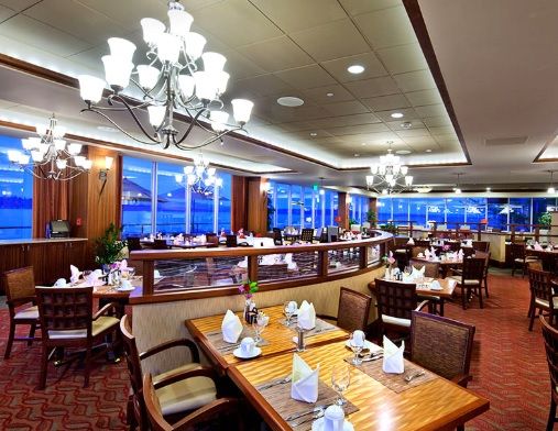 A beautifully designed restaurant interior featuring elegant chandeliers and neatly arranged tables.