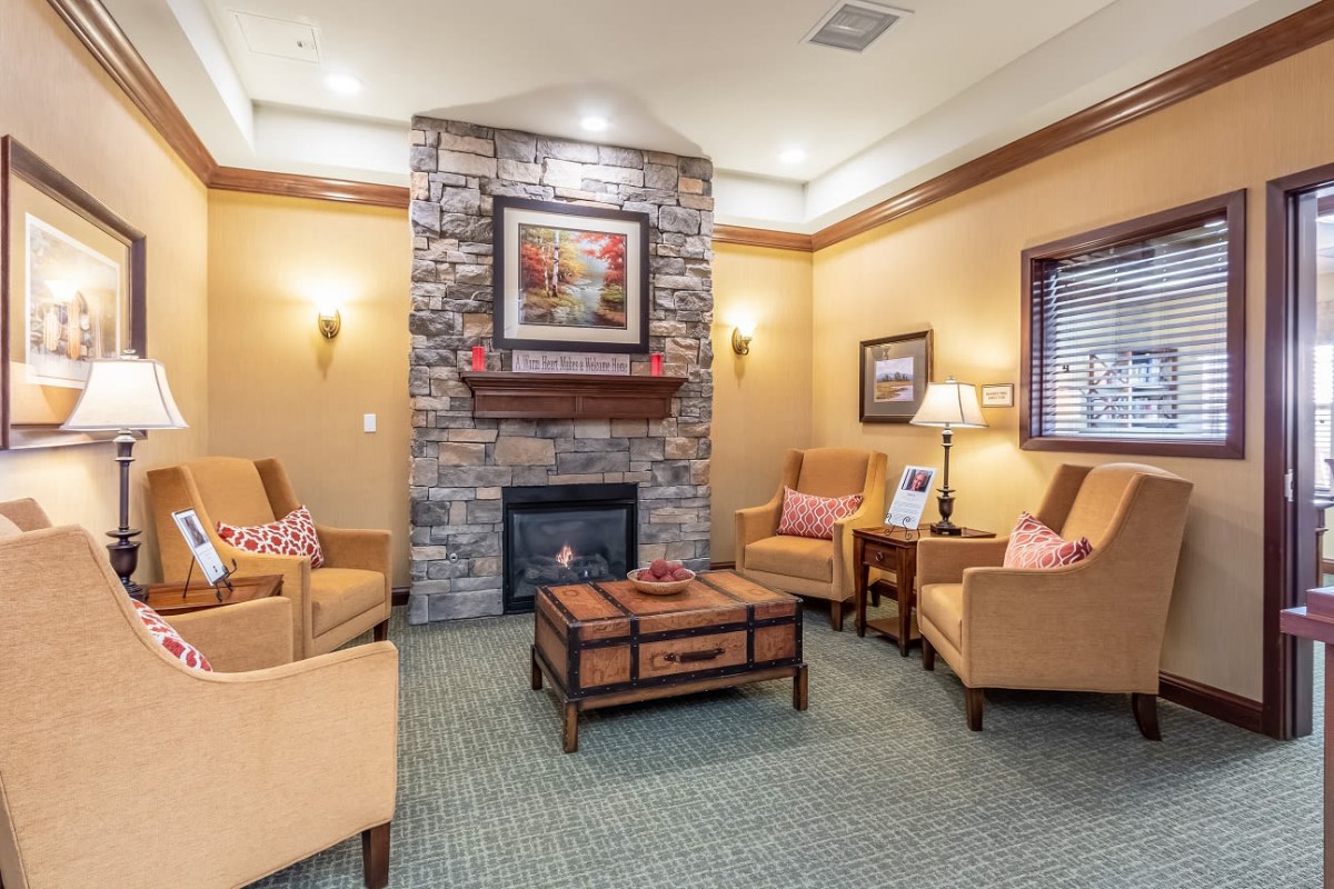 A cozy living room with a fireplace and comfortable seating.