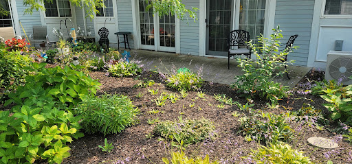 A serene garden space with a well-maintained landscape and patio furniture.