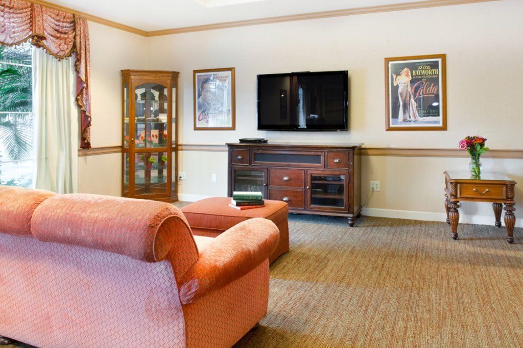 A cozy living room with a comfortable sofa, television, and decorative elements.