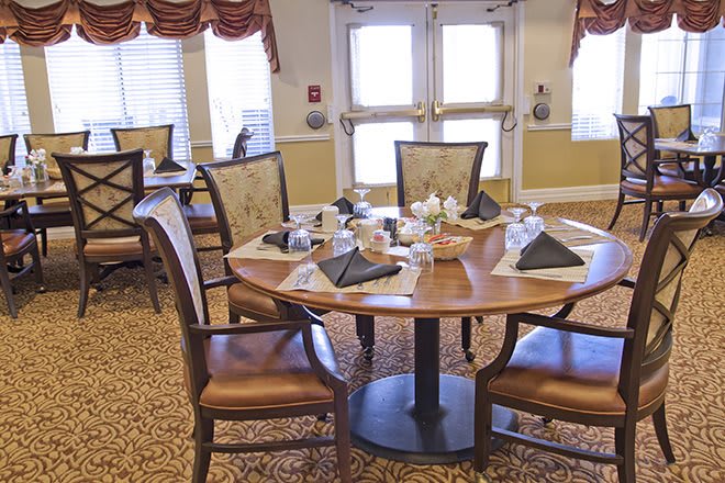 A neatly arranged dining room table set with plates and napkins.