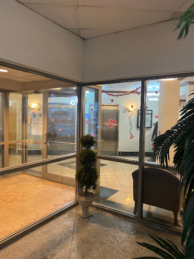 A spacious lobby showcasing glass doors and indoor greenery, creating an inviting atmosphere.