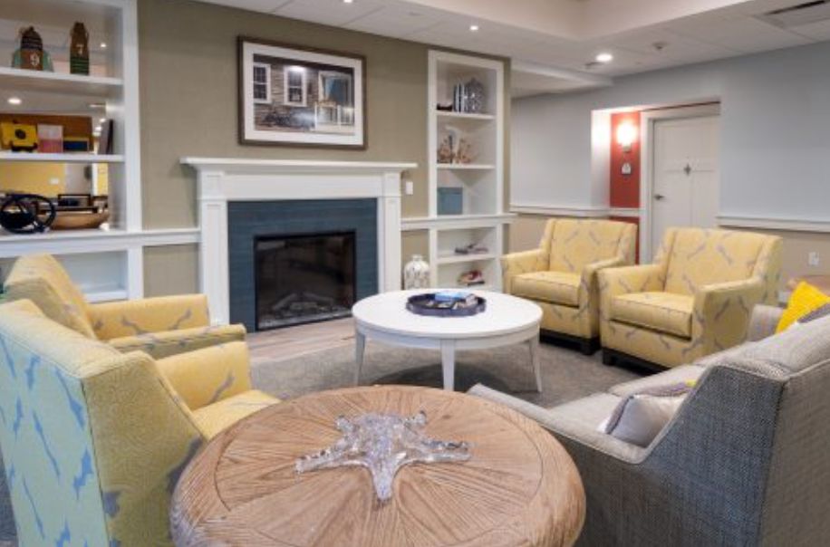 A cozy living room with comfortable seating and a fireplace.