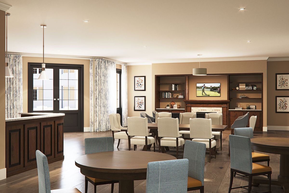 A spacious and modern dining room with elegant furniture and a television mounted on the wall.