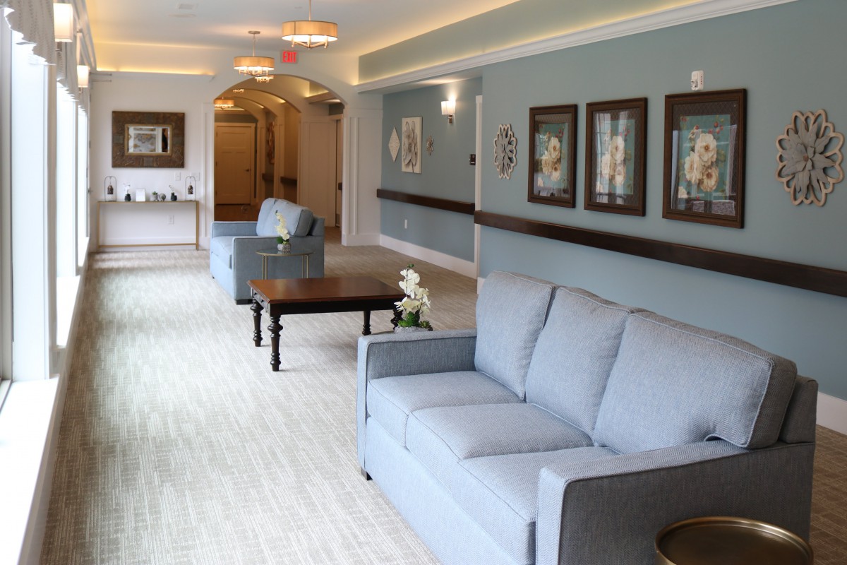 A well-decorated lobby area with sofas and artwork on the wall.
