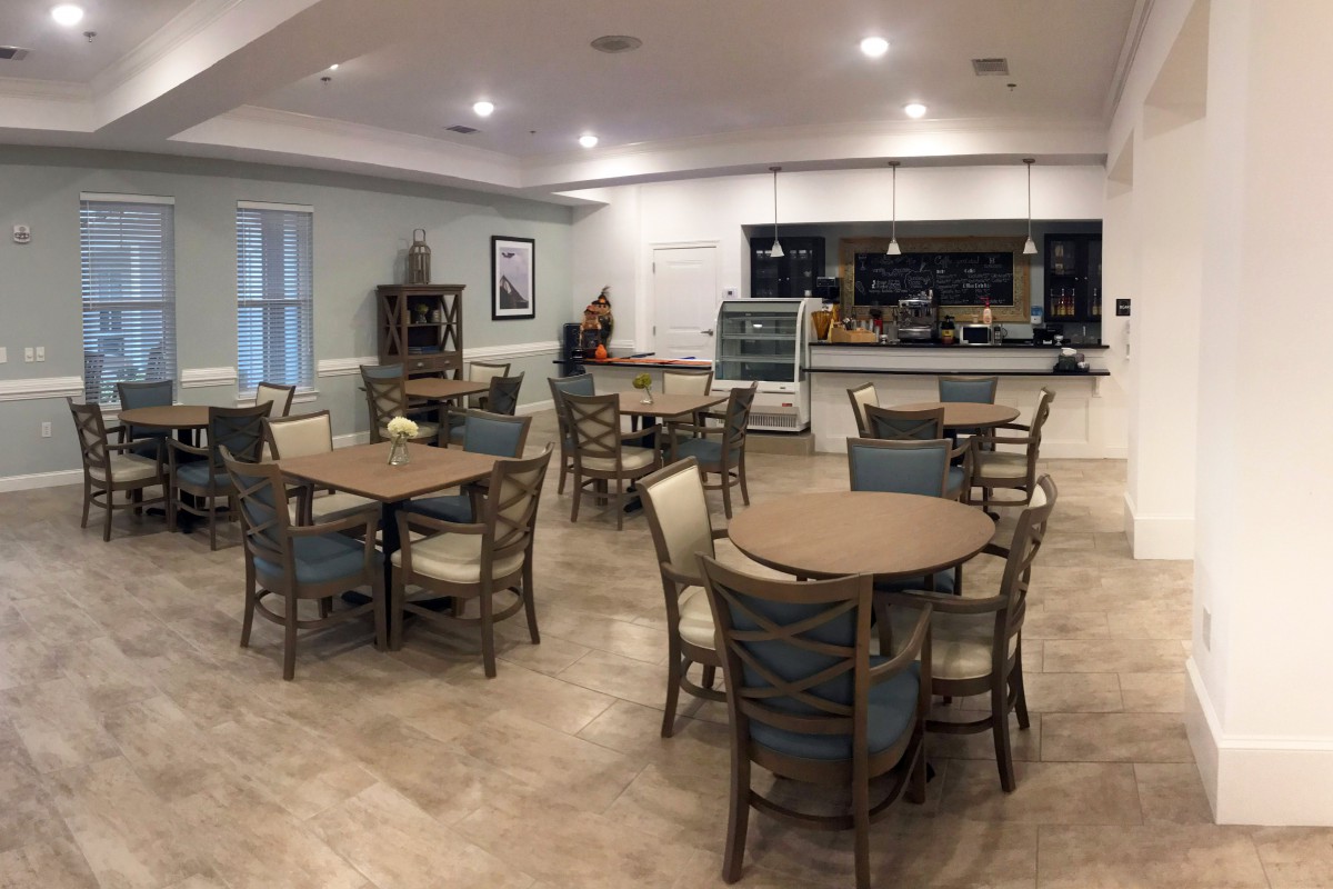 A modern dining area with neatly arranged tables and chairs.