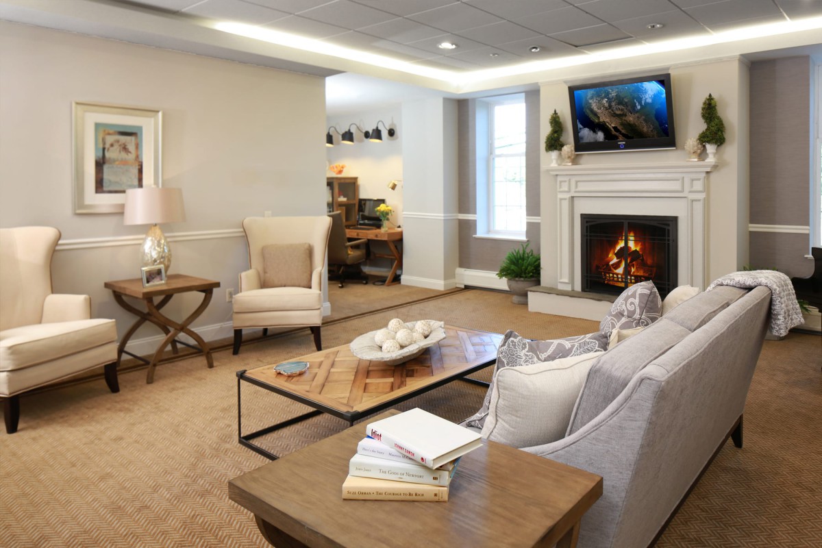 A cozy living room with a fireplace and comfortable seating arrangement.