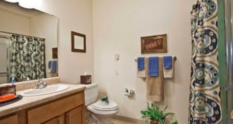 A neatly organized bathroom with towels and decor.