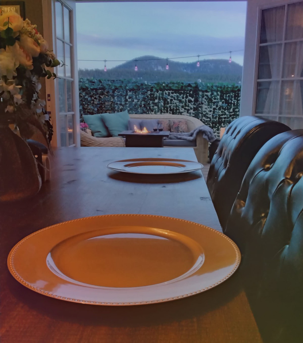 A cozy dining setup with a scenic mountain view through the window.