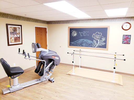 A dedicated fitness and rehabilitation space featuring exercise equipment and a chalkboard for motivational notes.
